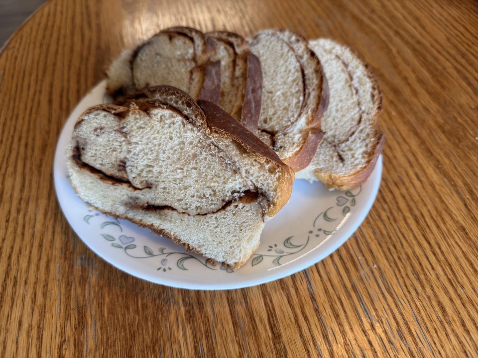 Slices of cinnamon swirl bread arranged on a patterned plate