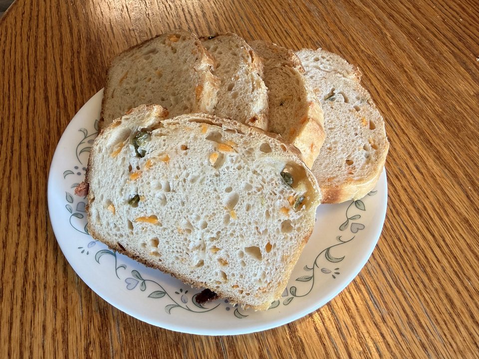 Sliced jalapeño and cheddar sourdough bread on a plate